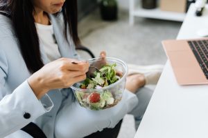 photo of a person eating a bowl of salad